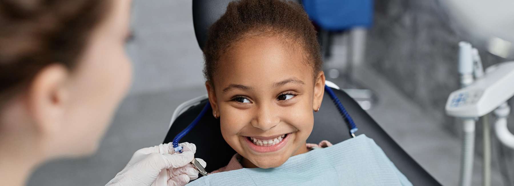 A little black girl smiling while getting a dental check up in Maple Ridge