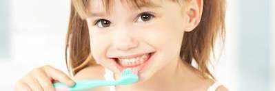 A picture of a child brushing her teeth