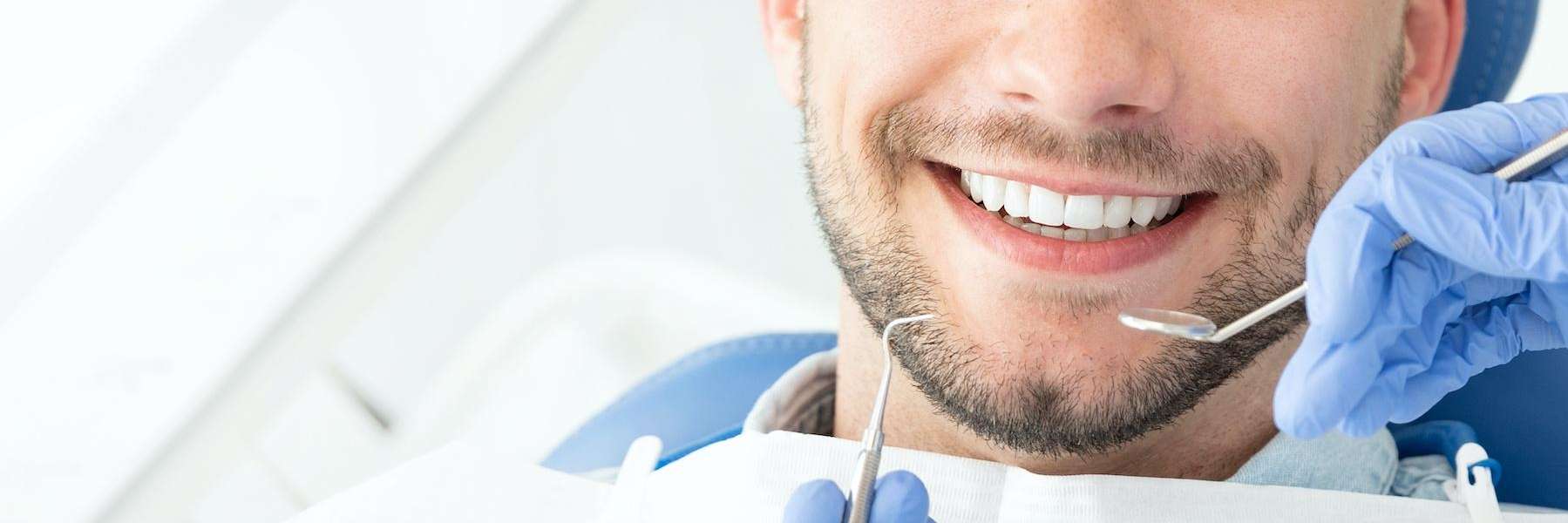A patient undergoing teeth cleaning in Meadow Ridge, BC