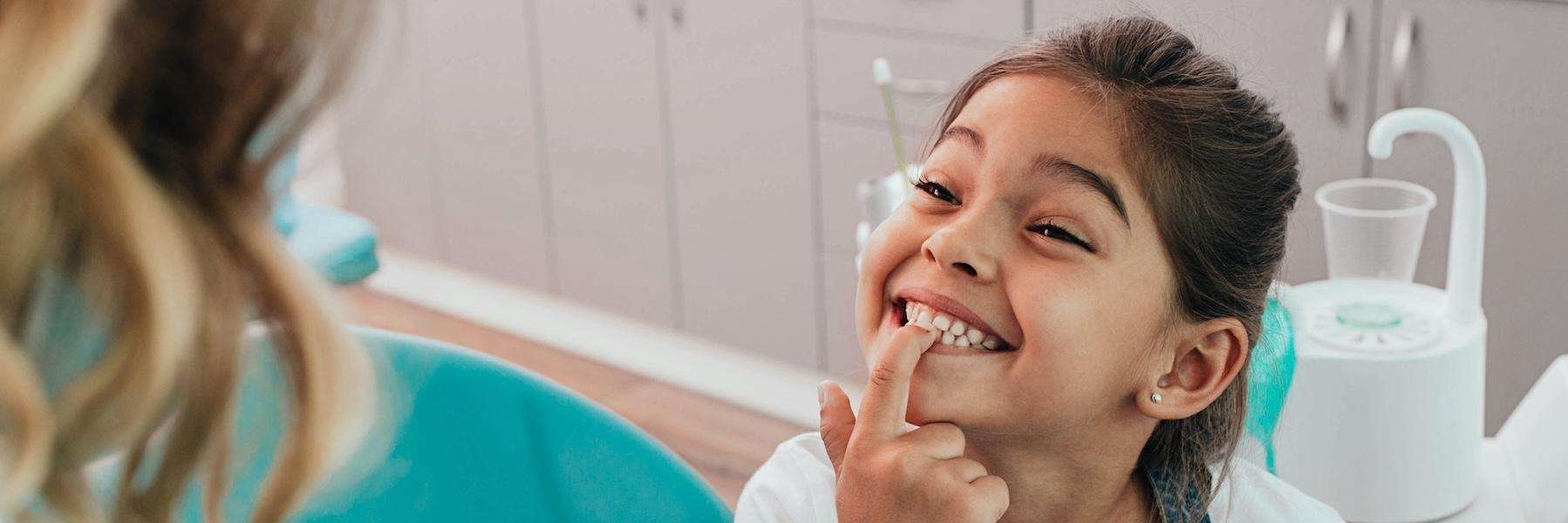 A child touching his teeth after dental check up in maple ridge bc