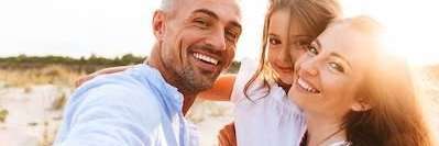 A family smiling on the beach | Dentist in Maple Ridge BC