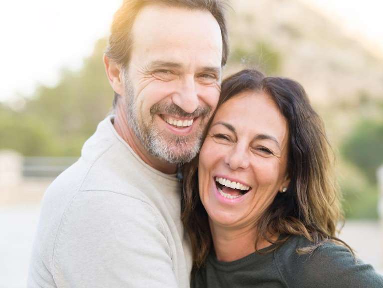 A happy couple after undergoing dental implants in Maple Ridge, BC
