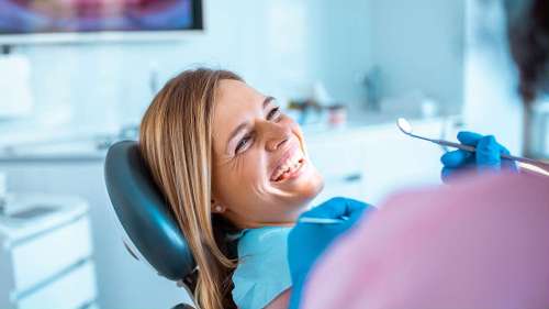 A woman smiling after getting a Comprehensive dental exams in Maple Ridge, BC