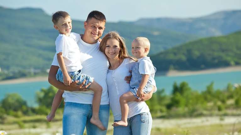 A family smiling at the lake | Maple Ridge Dentist