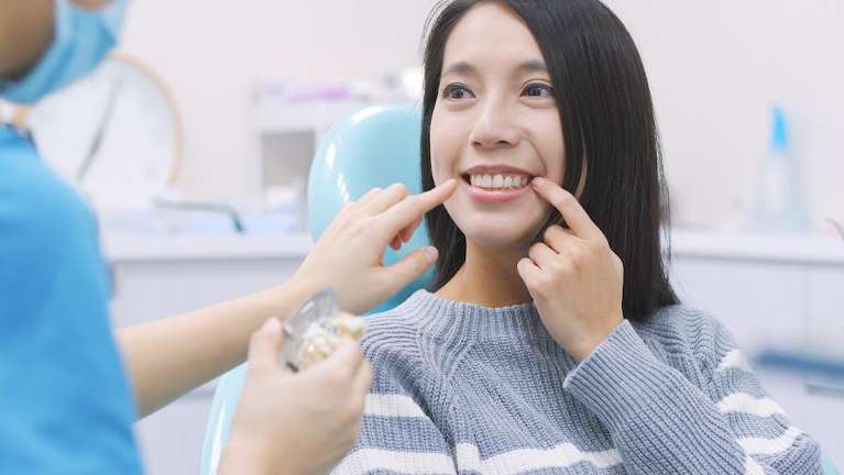 A smiling young woman during Dental Exam in Maple Ridge, BC