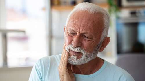 An elderly man in pain before an Emergency Dentist visit in Maple Ridge, BC