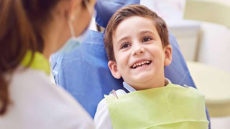 A smiling and relaxed child in a dental chair in Maple ridge bc