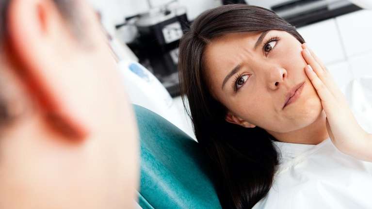 A woman with a chipped tooth