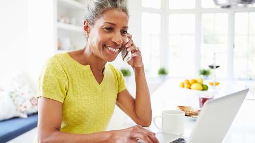 A black woman smiling after getting a Dental Crown Services in Maple Ridge, BC