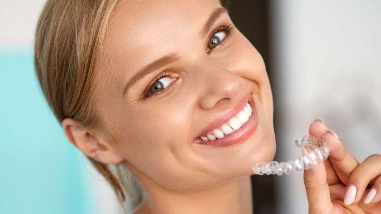A woman with Invisalign clear aligners in Maple Ridge, BC