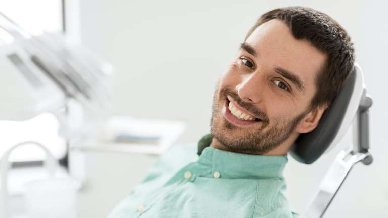A male patient after getting his teeth cleaned in Maple Ridge, BC