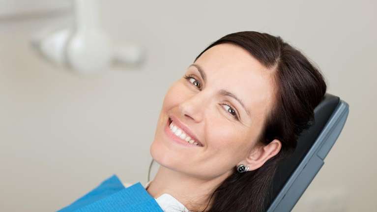 A woman receiving dental crowns