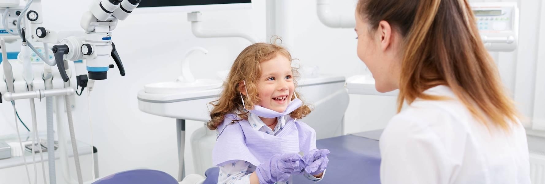 A child smiling at her dentist